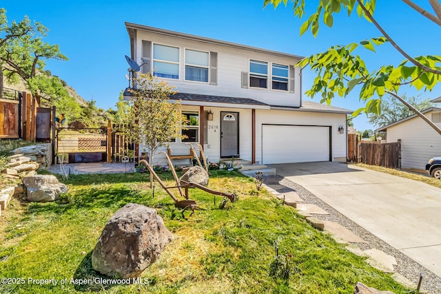 2618 Apache Ct, Rifle, CO 81650 - traditional home featuring concrete driveway, an attached garage, and a shingled roof