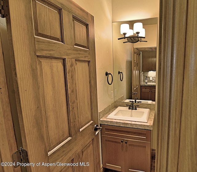 bathroom featuring vanity and backsplash