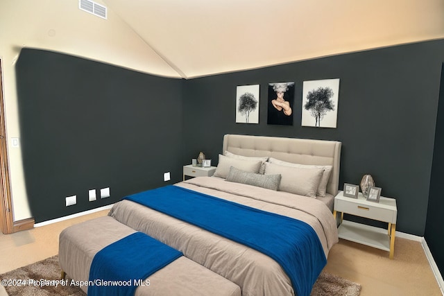 carpeted bedroom featuring lofted ceiling