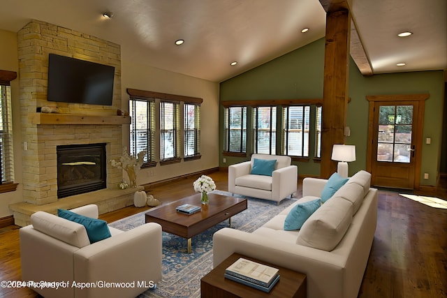 living room featuring hardwood / wood-style floors, a stone fireplace, and a wealth of natural light