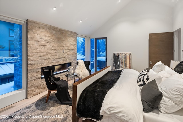 bedroom with a fireplace and vaulted ceiling