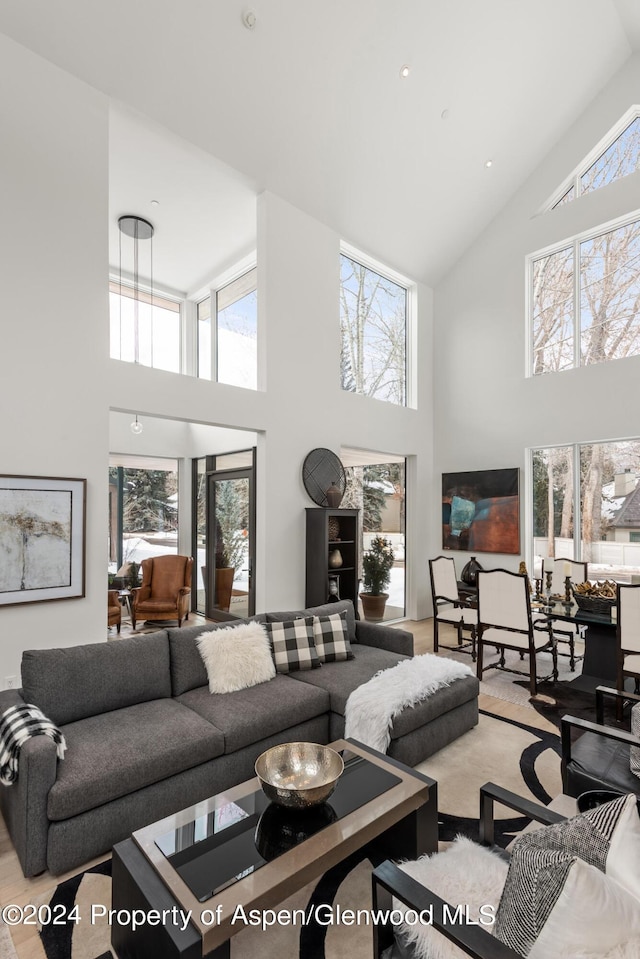 living room with high vaulted ceiling and plenty of natural light