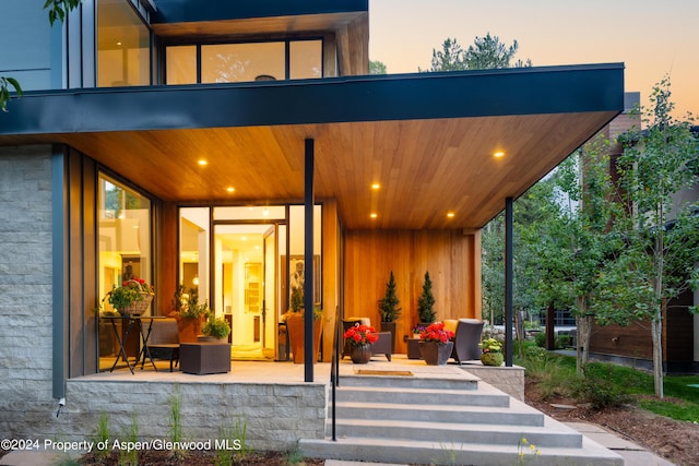 exterior entry at dusk featuring an outdoor hangout area