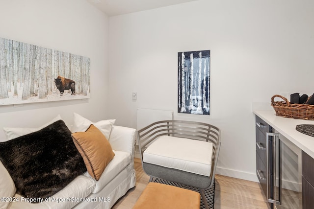 bedroom with wine cooler and light hardwood / wood-style flooring