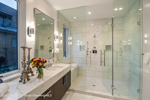 bathroom with vanity and a shower with door