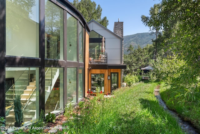 rear view of property featuring a mountain view