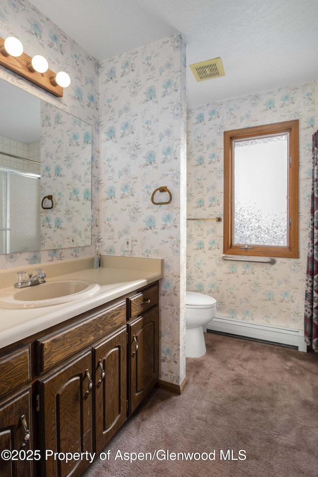 bathroom with vanity, walk in shower, toilet, and baseboard heating