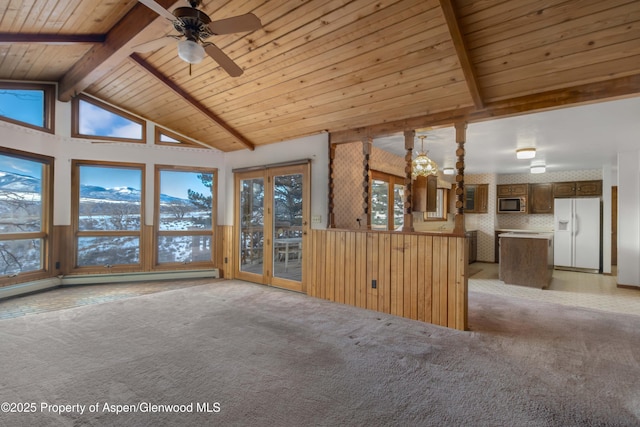 unfurnished living room with high vaulted ceiling, beamed ceiling, ceiling fan, wood ceiling, and light carpet