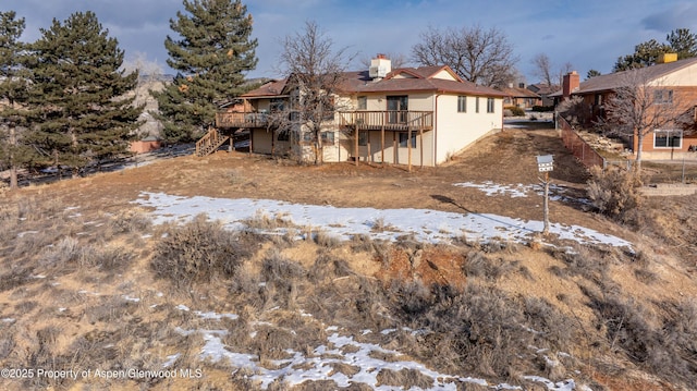 snow covered property featuring a deck