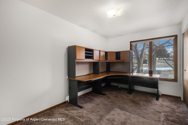 carpeted office space with built in desk