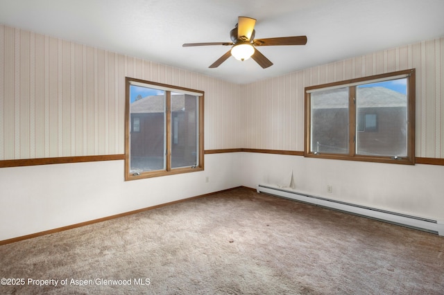 unfurnished room featuring carpet floors, a baseboard heating unit, and ceiling fan