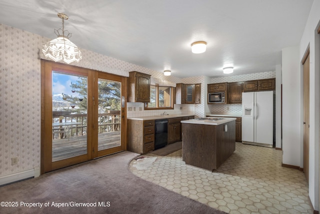 kitchen featuring a kitchen island, decorative light fixtures, built in microwave, black dishwasher, and white refrigerator with ice dispenser