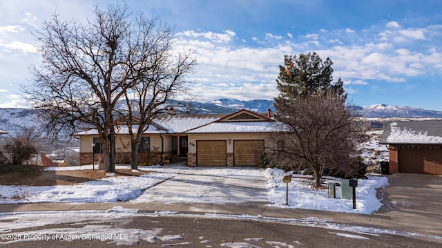 view of front of house with a garage and a mountain view