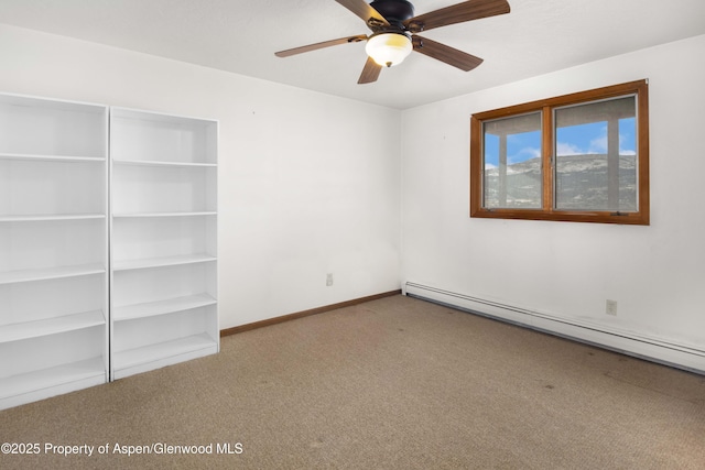 empty room with ceiling fan, light carpet, and a baseboard heating unit