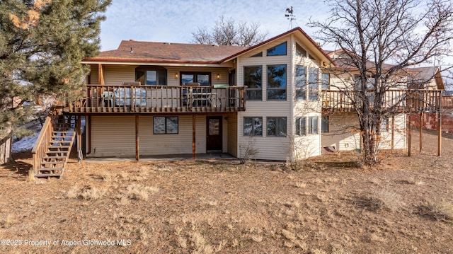 rear view of house with a wooden deck