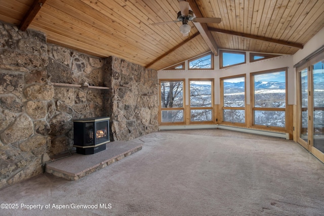 unfurnished living room featuring wood ceiling, beam ceiling, and a wood stove