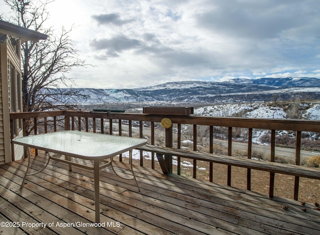 snow covered deck featuring a mountain view