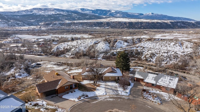 snowy aerial view featuring a mountain view