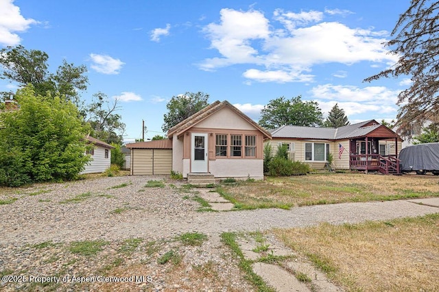 774 School St, Craig, CO 81625 - view of front of house with entry steps, stucco siding, and a wooden deck