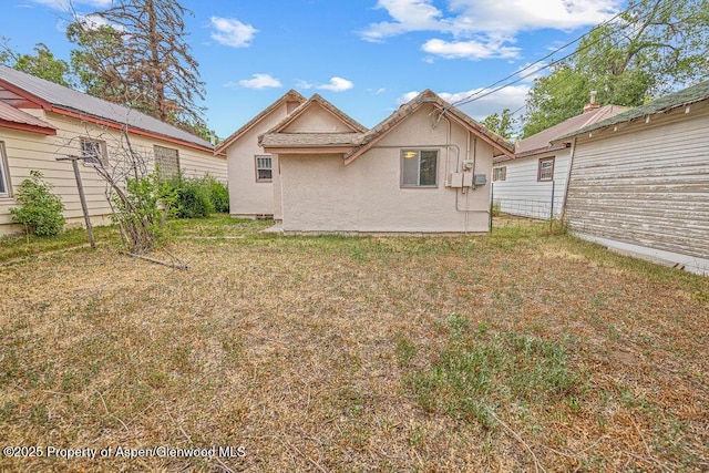 774 School St, Craig, CO 81625 - rear view of property with stucco siding and a yard
