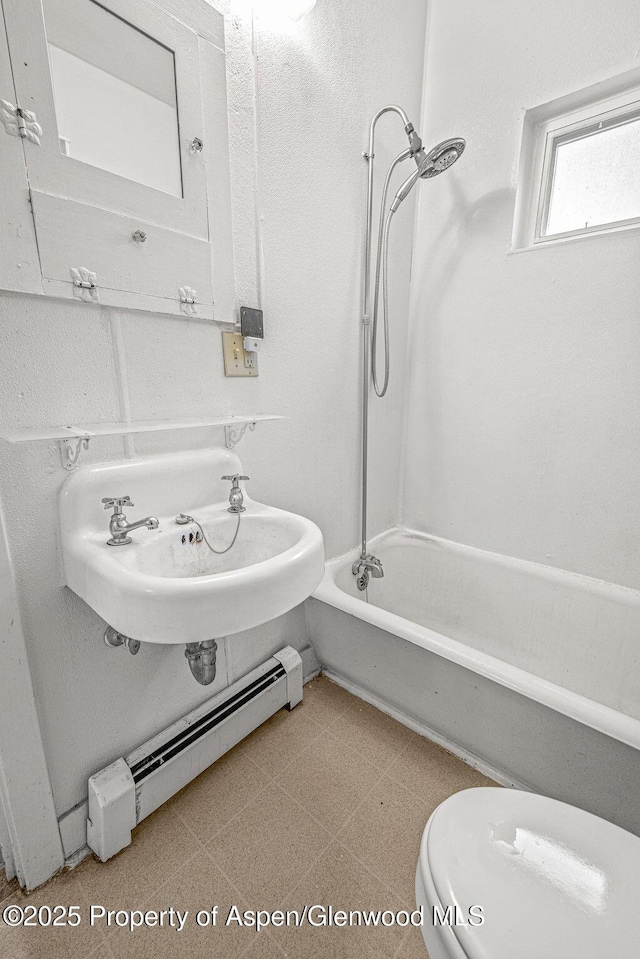 774 School St, Craig, CO 81625 - full bath with bathtub / shower combination, a baseboard heating unit, and tile patterned floors