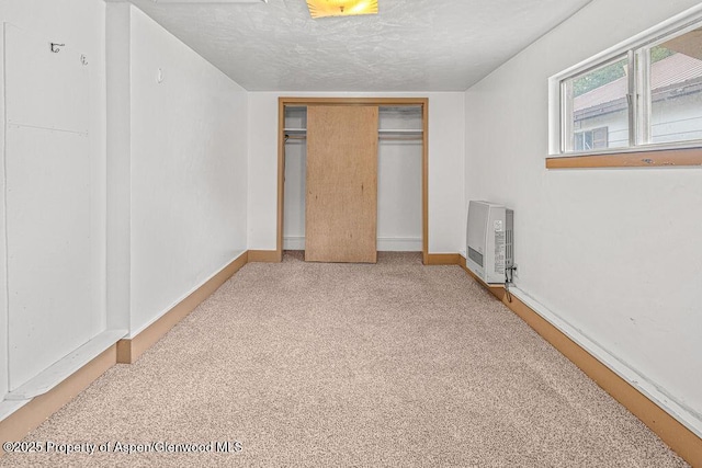 774 School St, Craig, CO 81625 - unfurnished bedroom featuring heating unit, a closet, and a textured ceiling