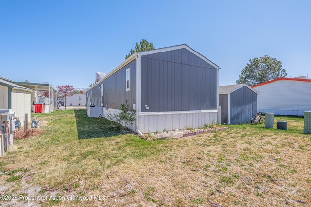 435 32nd Rd Unit 705, Clifton, CO 81520 - view of side of property featuring a lawn and a shed
