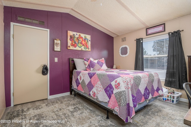 435 32nd Rd Unit 705, Clifton, CO 81520 - bedroom featuring wood finished floors, lofted ceiling, and a textured ceiling