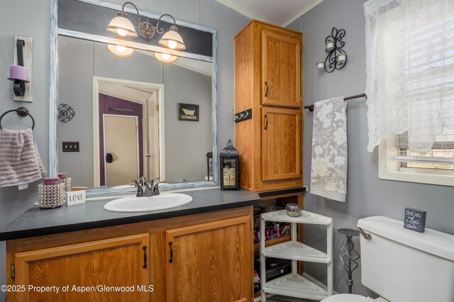 435 32nd Rd Unit 705, Clifton, CO 81520 - kitchen featuring appliances with stainless steel finishes, under cabinet range hood, dark countertops, vaulted ceiling, and a textured ceiling
