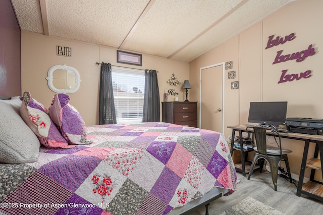 435 32nd Rd Unit 705, Clifton, CO 81520 - bedroom with wood finished floors, a textured ceiling, vaulted ceiling, and an office area