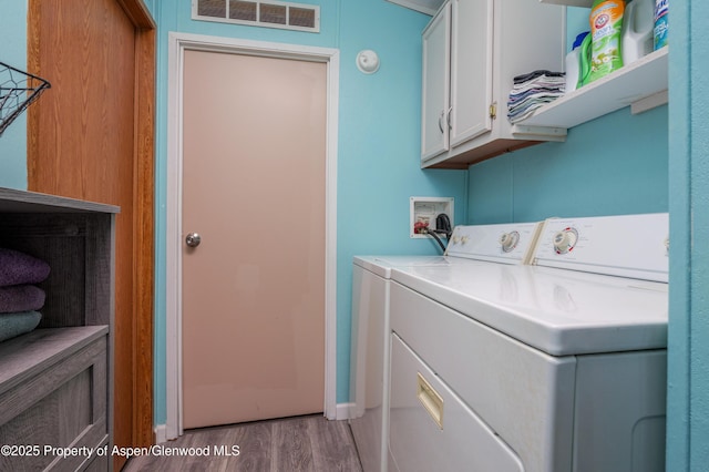 435 32nd Rd Unit 705, Clifton, CO 81520 - laundry room featuring cabinet space, washing machine and clothes dryer, and wood finished floors