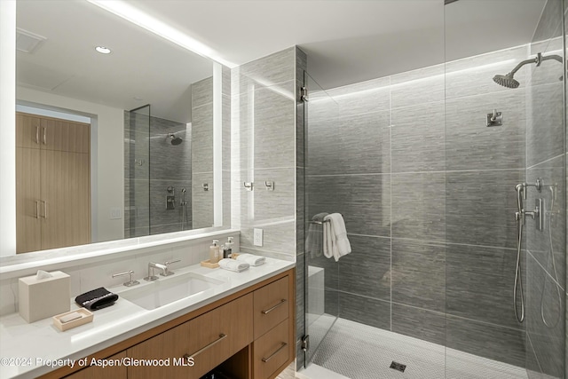 bathroom with vanity and a shower with shower door