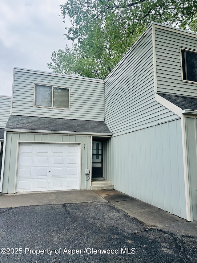 1024 E Ave, Rifle, CO 81650 - view of front of house featuring a shingled roof and asphalt driveway