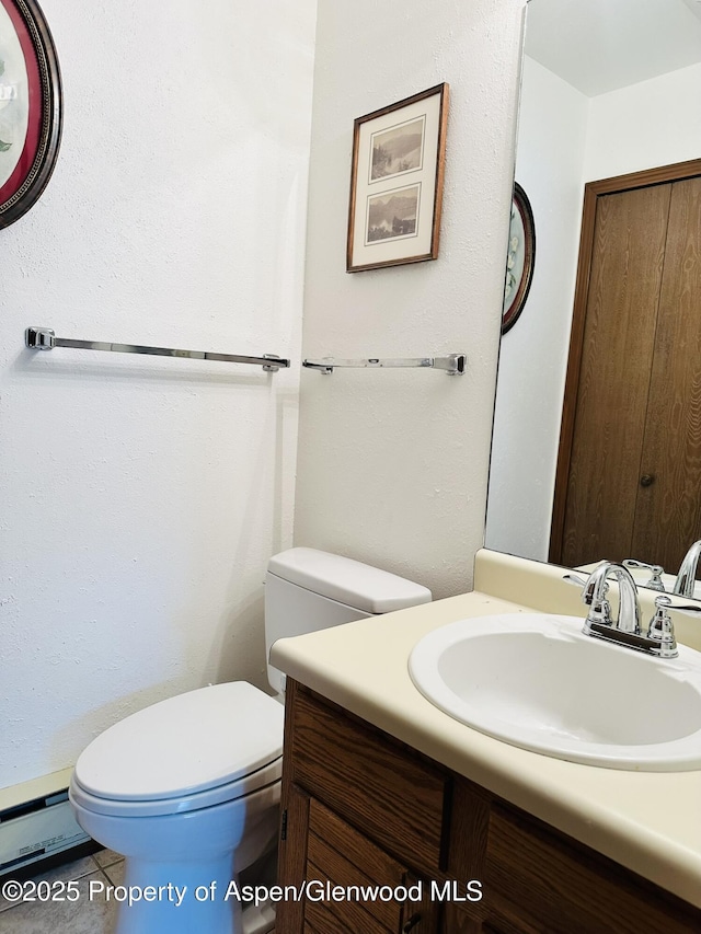 1024 E Ave, Rifle, CO 81650 - half bathroom with vanity, toilet, and baseboard heating
