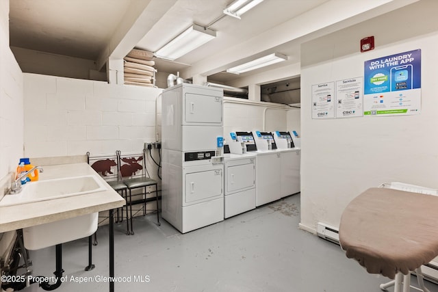 600 Carriage Way Unit L-12, Snowmass Village, CO 81615 - shared laundry room featuring stacked washer / dryer, concrete block wall, and washing machine and clothes dryer