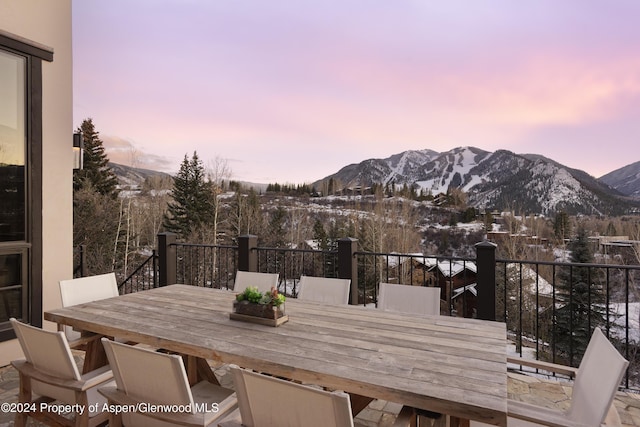 snow covered deck featuring a mountain view