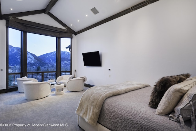 carpeted bedroom featuring lofted ceiling with beams and ornamental molding