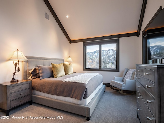 carpeted bedroom with vaulted ceiling with beams