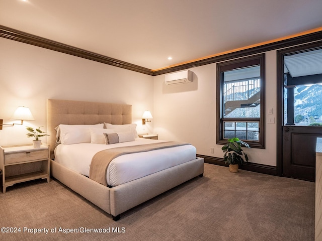 bedroom with a wall unit AC, carpet floors, and ornamental molding