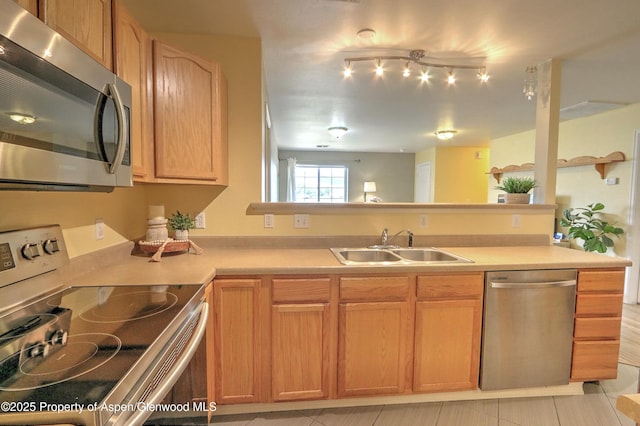 41 Angelica Cir, Parachute, CO 81635 - kitchen featuring appliances with stainless steel finishes, a sink, light countertops, a peninsula, and light tile patterned flooring