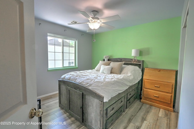 41 Angelica Cir, Parachute, CO 81635 - bedroom with light wood-style flooring, ceiling fan, and baseboards