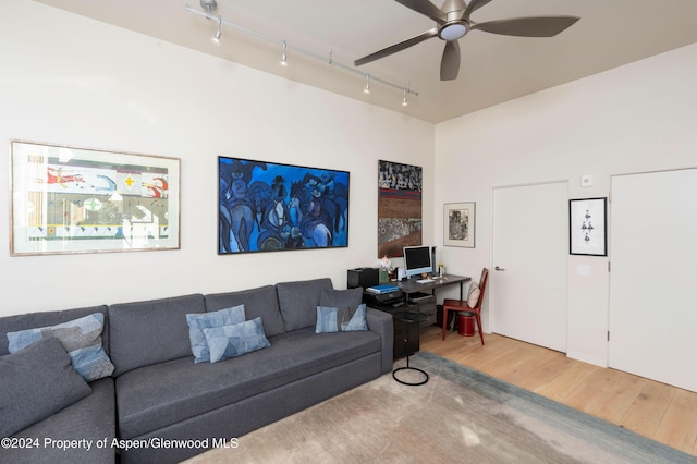 living room with ceiling fan, track lighting, and wood-type flooring