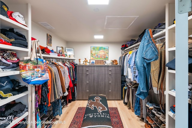 spacious closet with light hardwood / wood-style floors