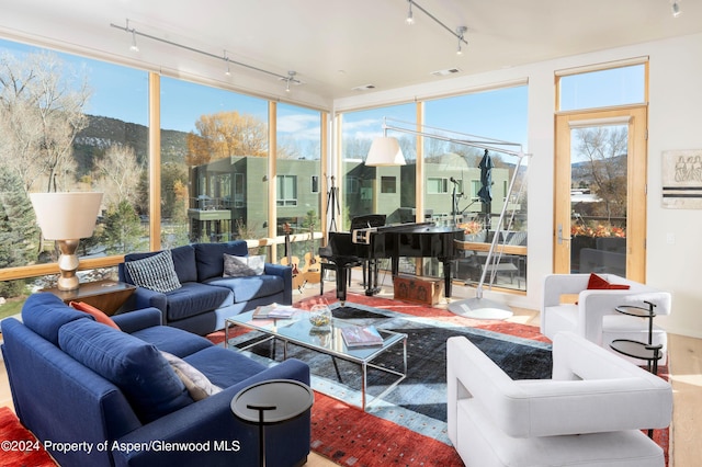 sunroom / solarium featuring a mountain view and a healthy amount of sunlight