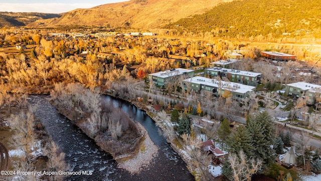 drone / aerial view featuring a water and mountain view