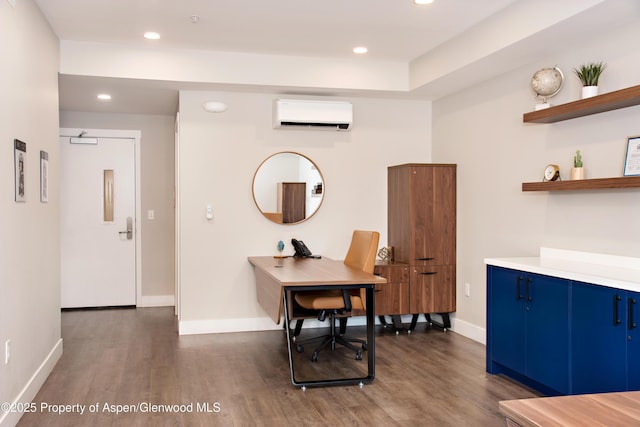 253 Wulfsohn Rd Unit 122, Glenwood Springs, CO 81601 - office area featuring dark wood finished floors, baseboards, and an AC wall unit