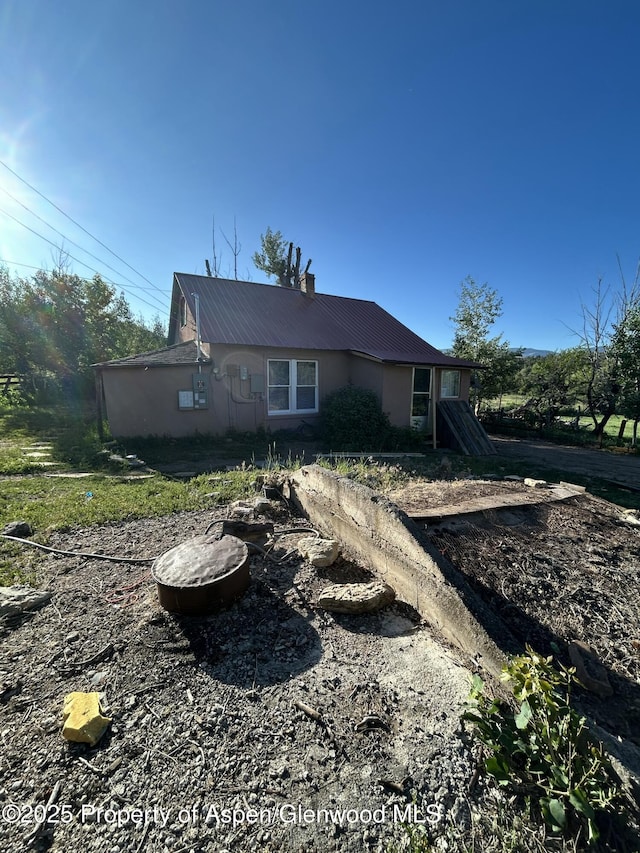 16125 57 8/10 Rd, Collbran, CO 81624 - view of front of property with a metal roof and a chimney