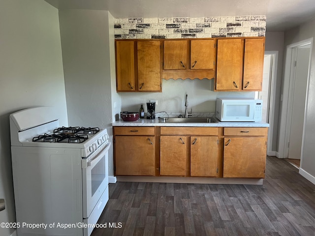 16125 57 8/10 Rd, Collbran, CO 81624 - kitchen featuring white appliances, brown cabinetry, dark wood-type flooring, and light countertops