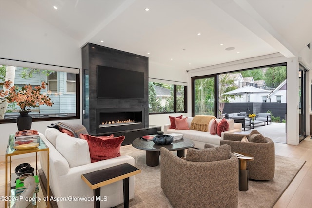 living room with a fireplace and light wood-type flooring