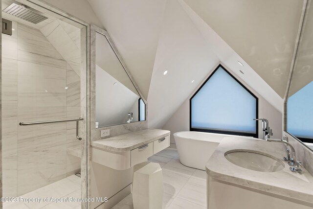 bathroom featuring vanity, lofted ceiling, and independent shower and bath